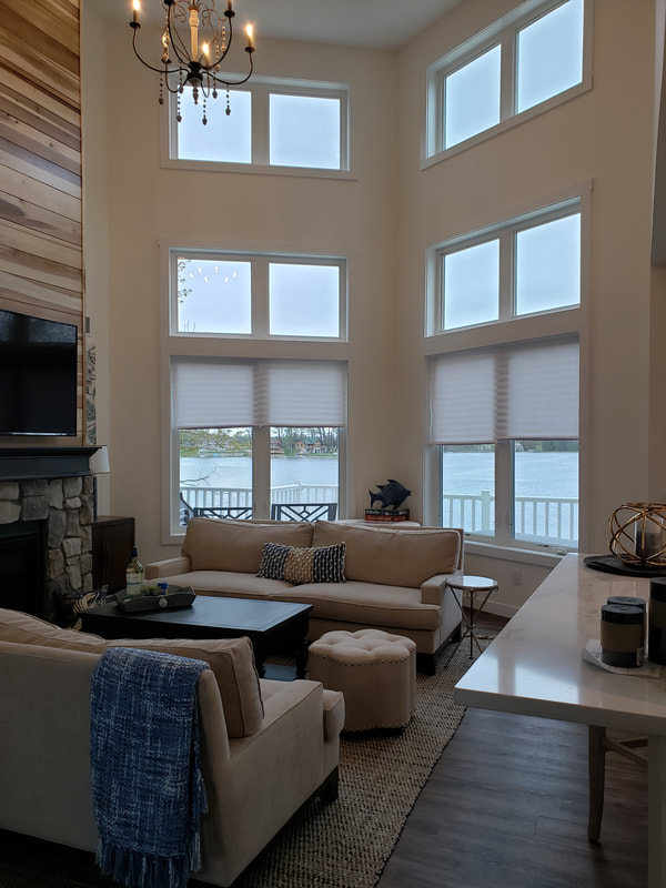 Open concept living room with tall windows